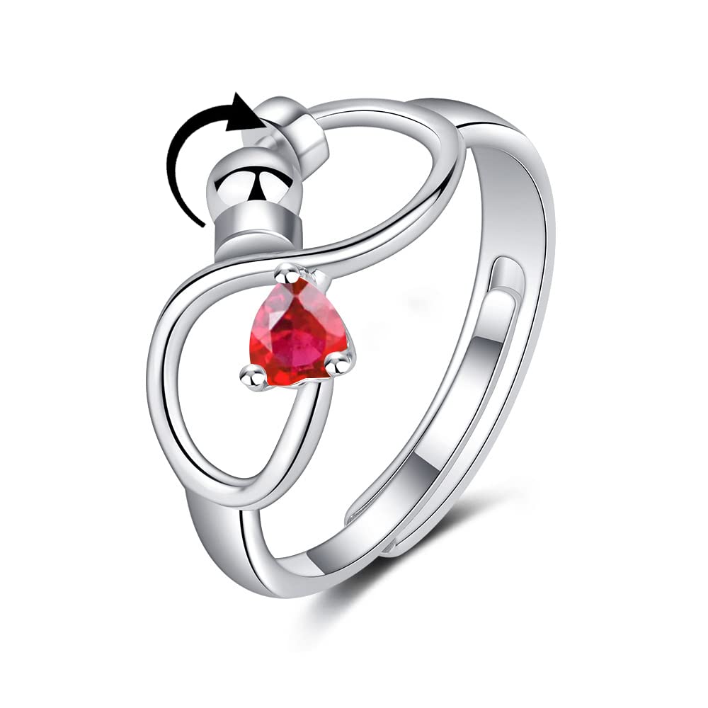 Silver ring with a red gemstone on a white background