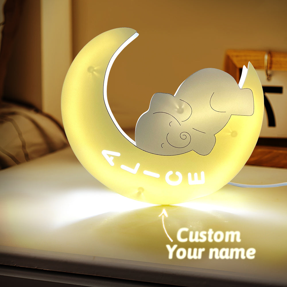 Decorative night light shaped like a crescent moon with a cat design, featuring customizable text on a surface.