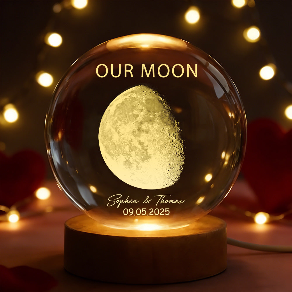 Glowing crystal ball with moon engraving and personalized text against a warm, blurred background.