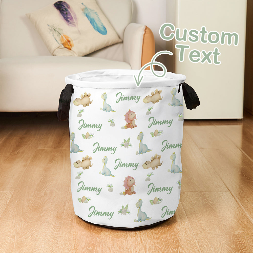 White laundry basket with dinosaur pattern and 'Jimmy' text on a wooden floor.