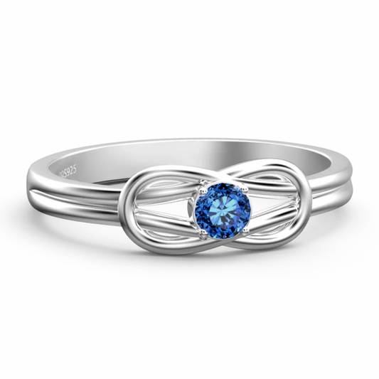 Silver ring with a blue gemstone on a white background