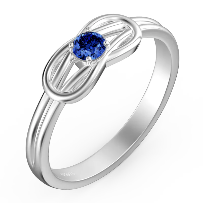 Silver ring with a blue gemstone on a white background