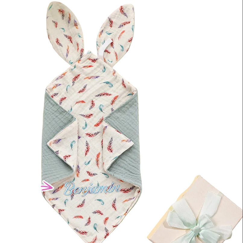 Bunny-shaped towel with colorful pattern on a yellow background