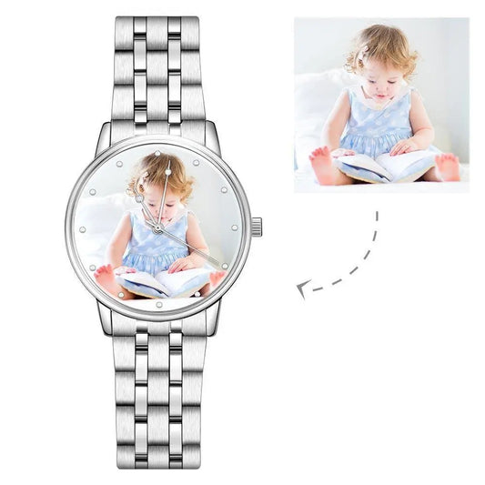 Silver watch with a photo of a child on the dial, inset image of the child reading a book.
