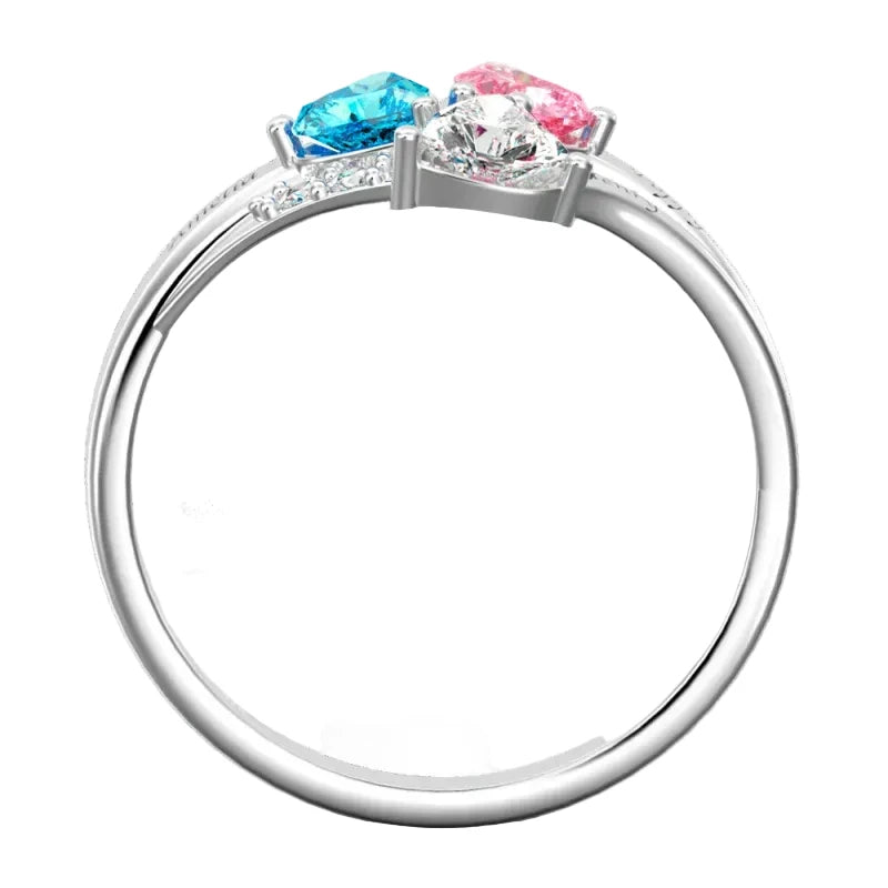 Silver ring with blue and pink gemstones on a white background