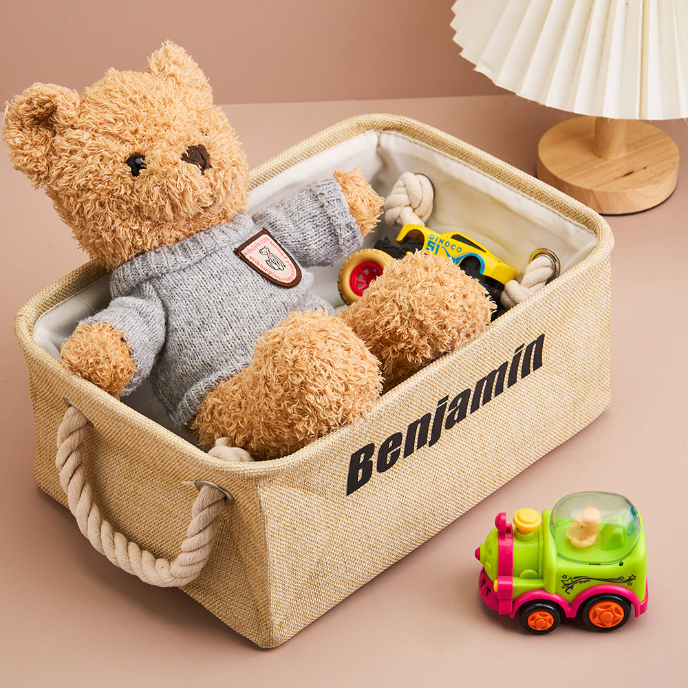 Teddy bear in a storage basket with toys on a beige background