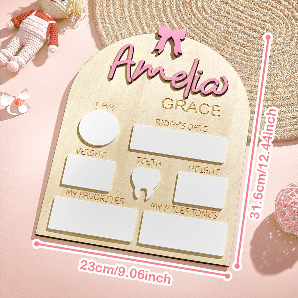 Wooden baby milestone board with 'Amelia Grace' on a pink background