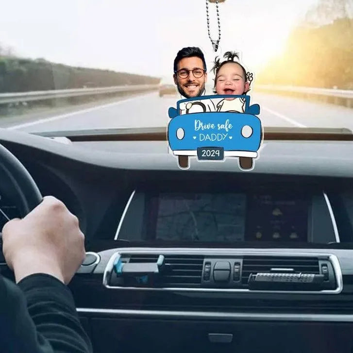 Car interior with a personalized 'Drive safe DADDY 2024' car air freshener hanging from the rearview mirror.
