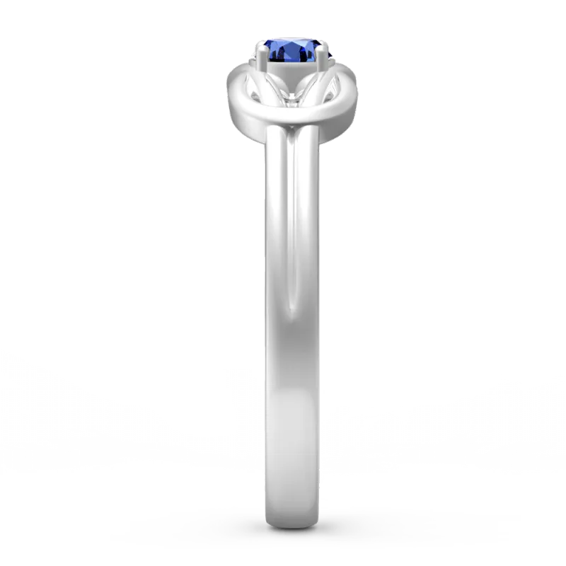 Silver ring with a blue gemstone on a white background