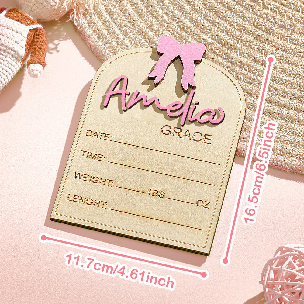 Wooden baby milestone card with 'Amelia Grace' on a pink background