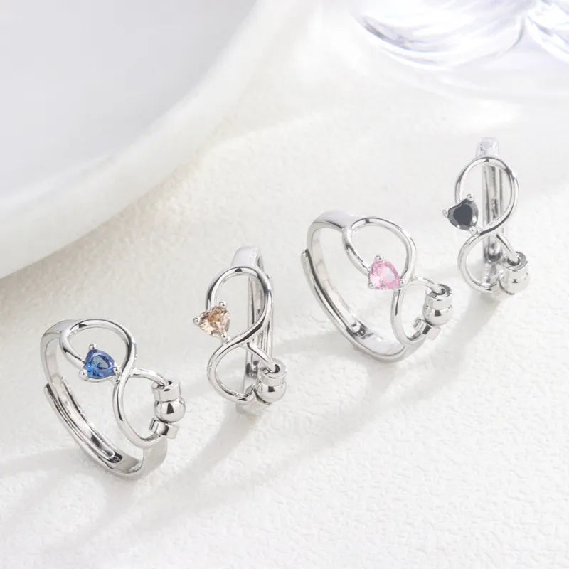 Set of silver rings with gemstones on a white background
