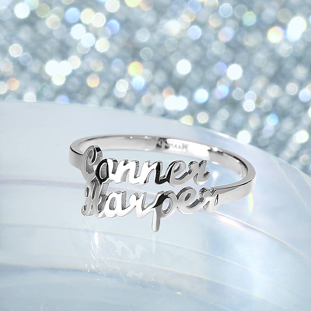Silver ring with 'Connor Harper' engraving on a glittery background