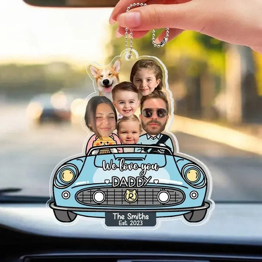 Personalized keychain with family photo and 'We love you DADDY' text on a car dashboard.