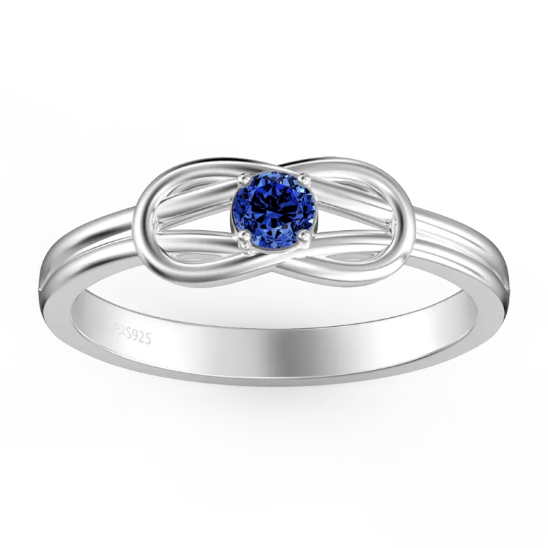 Silver ring with a blue gemstone on a white background