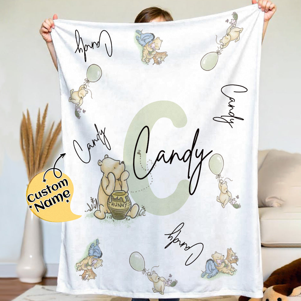Person holding a blanket with cartoon characters and 'Candy' text in a home setting