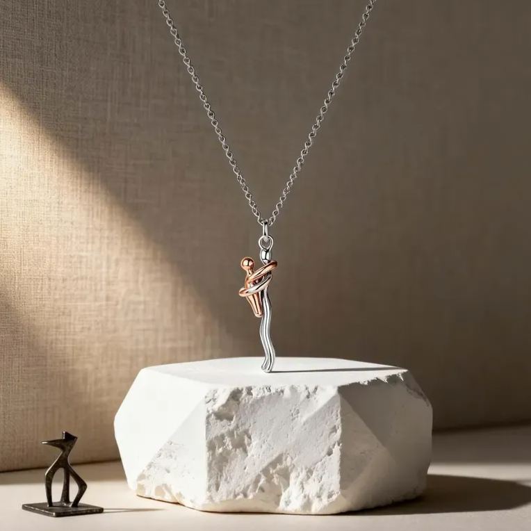 Necklace with a dancing figure pendant on a textured surface
