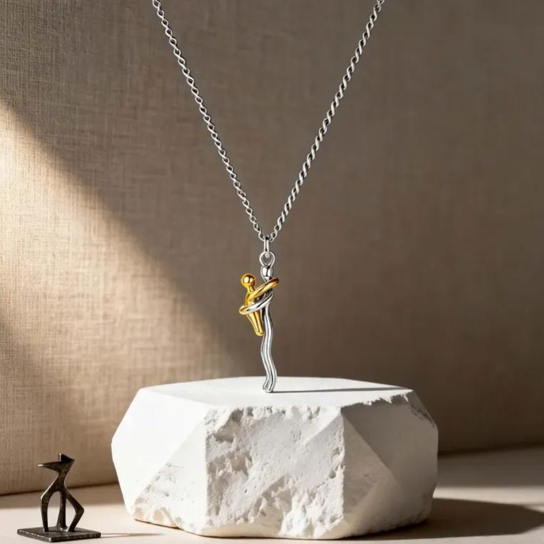 Necklace with a dancing figure pendant on a textured surface